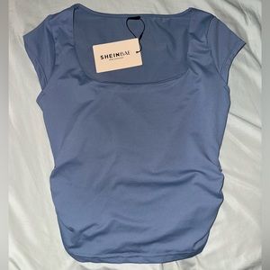 Short sleeve everyday top. Material is dry-fit. Not too cropped.